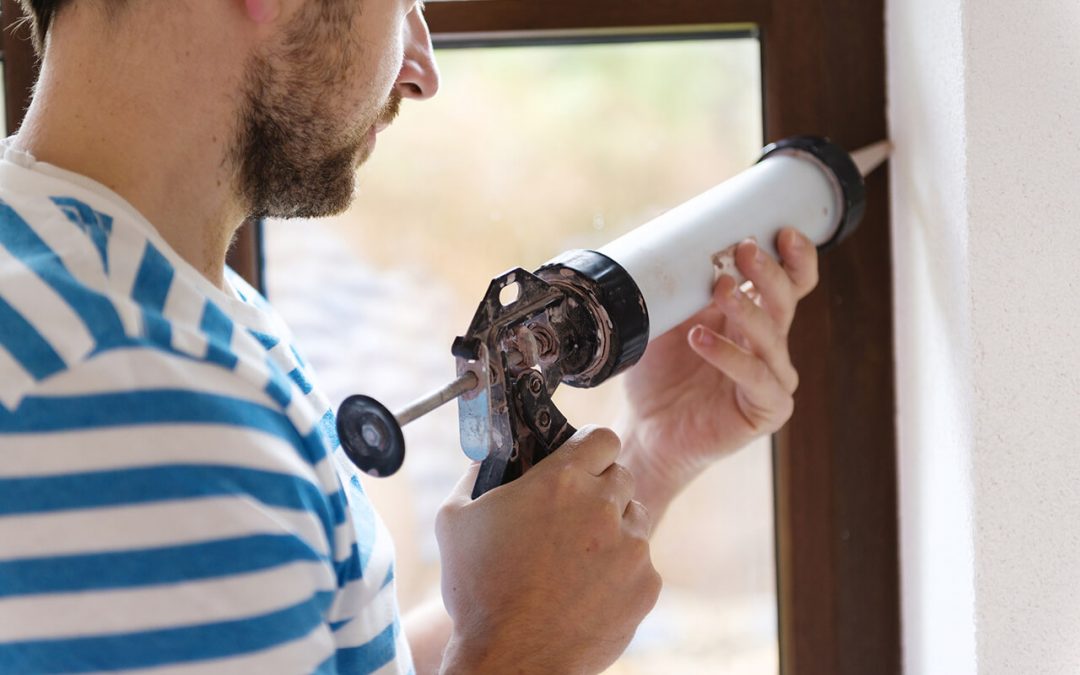 fall home improvement projects include sealing gaps around windows with caulk